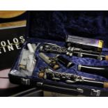 A cased Boosey and Hawkes clarinet, together with a collection of clarinet sheet music.