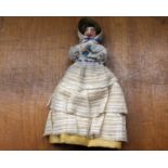 A 19th century wooden peg doll, measuring 12cm tall.