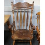 A 20th century part oak and elm Windsor style slat back rocking chair, with later replacement top,