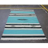 A modern North African flat weave rug in aqua green and cream bonded. 207cm x 137cm.