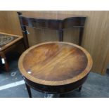 A reproduction mahogany finish drum table, fitted single drawer together with a serpentine front