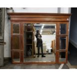 A substantial early 20th century walnut framed over mantle mirror. The large central mirror