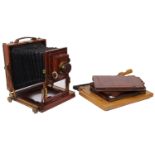 A Thornton Pickard mahogany cased camera with a F7.7 lens along with three dark slides and a