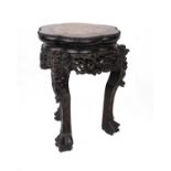 An Oriental carved hardwood vase stand with a marble top