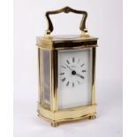 A brass and bevelled glass cased carriage clock, face marked Henley on white enamel with Roman