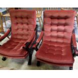 A pair of 20th century pink upholstered button back Show wood arm chairs.
