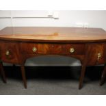 A Regency string inlaid mahogany bow fronted sideboard, the central drawer flanked with two cabinets