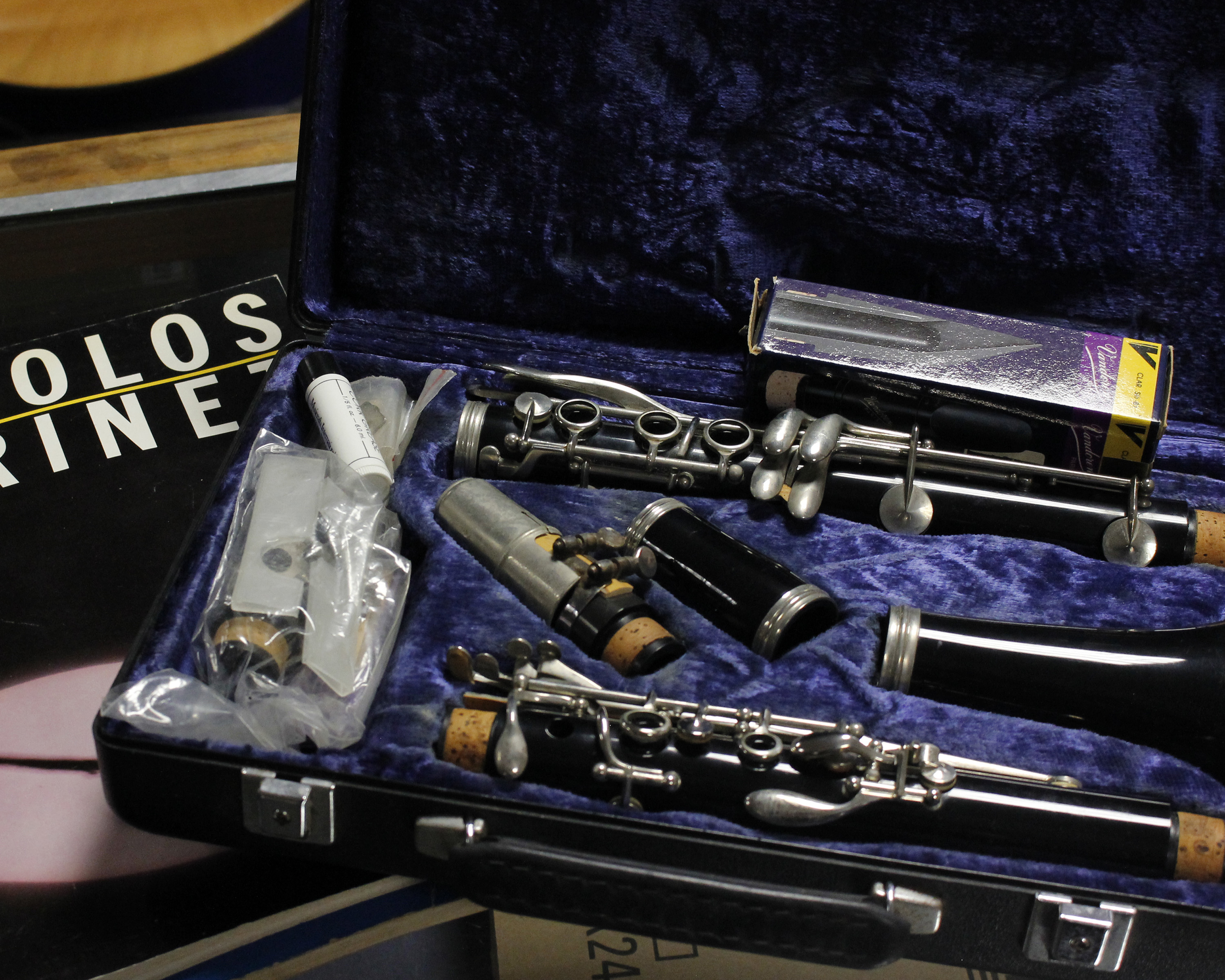 A cased Boosey and Hawkes clarinet, together with a collection of clarinet sheet music.