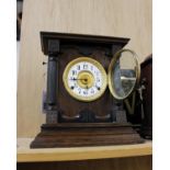 A late 19th century oak cased mantle clock by Fattorini & Sons, Bradford, the enamel face with a