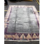 A large modern Tabat woollen carpet with a grey central field and purple geometric border. 350cm x