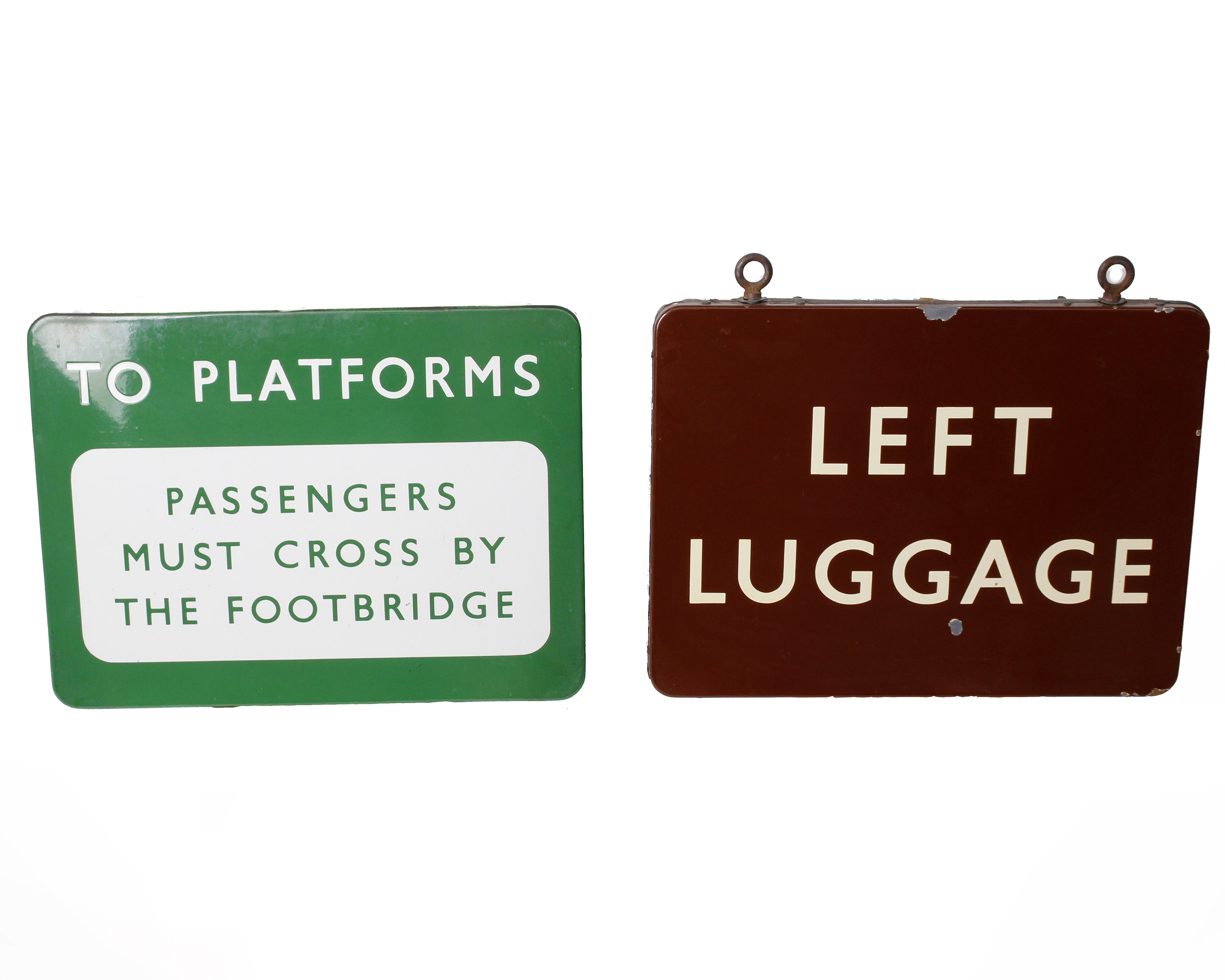 A British Railways enamel Left Luggage sign along with a To Platforms via Footbridge enamel sign.