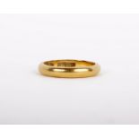 A 22ct gold ring, the plain polished band, stamped 18 with full hallmarks, ring size K 1/2, 4.3g