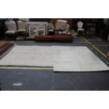 A heavy knotted oatmeal colour woollen rug together with a modern cream ground rug. 201cm x 193cm.