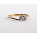 An 18ct illusion two diamond ring in a crossover setting, stamped 18ct Plat, size O 1/2, 2g