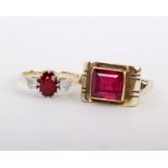 A synthetic ruby ring, the square cut synthetic ruby between scrolled shoulders, stamped with