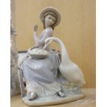 A Lladro porcelain figure of a seated girl with a goose, together with a Lladro porcelain figural