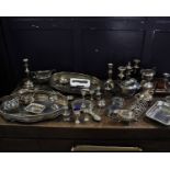 A large collection of silver plated items to include a boxed cutlery set for 12, trays, candlesticks
