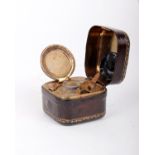 A leather Moroccan bound portable inkwell.