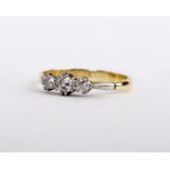 A three stone diamond ring, set with three brilliant cut diamonds, stamped 18ct, size N, 2.4g