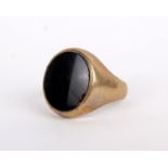 A 9ct gold signet ring, the oval black panel on a wide shank, stamped 375, ring size P, 8.2g