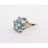 A 9ct gold blue topaz ring set with a cluster of circular cut blue topaz