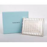 A silver desk calendar by Tiffany & Co., the rectangular calendar with reeded detail, with a leather