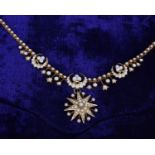 A gold and seed pearl necklace, the front section with three crescent shaped panels set with seed