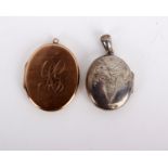 A 9ct gold oval engraved locket with a monogram, stamped 375 with Chester hallmarks, 3.9cm long, 9.