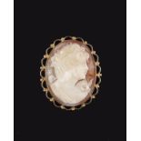 A 9ct gold shell cameo, the oval shell cameo carved with a lady's profile, stamped 375 with full