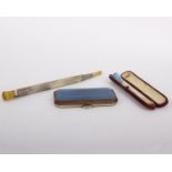 An enamel cigarette holder, with guilloche blue enamel, 9.7cm long; a cheroot holder; and a blue