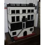 A substantial mansion style dolls house in black and white