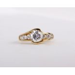 A 14 carat gold synthetic cubic zirconia ring, the circular cut synthetic cubic zirconia between