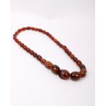 A string of amber coloured beads. 80g