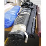 Two full rolls of black duchess satin (22m by 150cm) together with four other rolls of black duchess