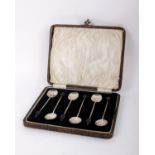 A boxed set of sterling silver coffee spoons with bean finials
