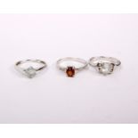 Three 9ct white metal gem set ladies rings. Size N. 6.6g