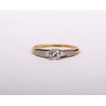 An 18ct gold and platinum single stone diamond ring. Central brilliant cut diamond in four claw