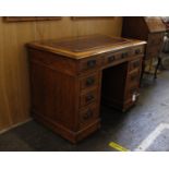 An Edwardian Oak Pedestal Desk with Leather Inset TopThis piece has nine drawers and castors on