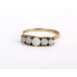 A 9ct gold opal ring set with five circular cabochon opals