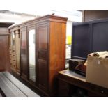 An Edwardian Mahogany Mirrored Three Door WardrobeWith intricate wooden detailing, four drawers,