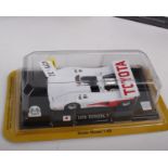 A collection of thirteen 1:43 scale motor racing model cars from multiple manufacturers. To include