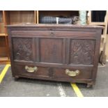 An 18th Century Carved Oak Coffer on WheelsTop-opening with two brass-handled drawers. Inscribed '