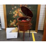 An Edwardian oval mahogany Tyrela gramophone, the case with printed floral and swag decoration