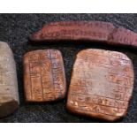 Three replica clay tablets depicting early writing forms, possible Scandinavian example, together