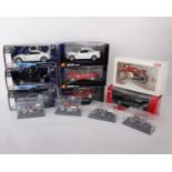 Seven boxed 1:24 scale model cars of different brands and from multiple model manufacturers. Mondo