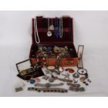 A collection of costume jewellery in a leather jewellery box to include a selection of brooches,