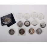 An assortment of 12 commemorative Crown-sized coins (£5, Crown, 25np) and 2 Halfcrowns from
