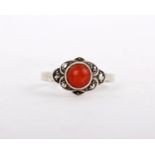 A Coral and Marcasite ring, the circular cabochon coral between cut marcasite, size L 1/2