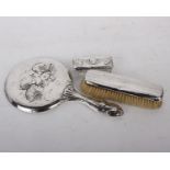 A sterling silver dressing table set to include a hand held mirror a brush and a silver topped glass