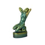 An Art Deco Zsolnay Pecs figurine, modelled as a female nude in kneeling pose with her hand